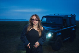 brunette-tough-woman-wearing-black-outfit-standing-in-front-of-a-black-landrover-defender-110 