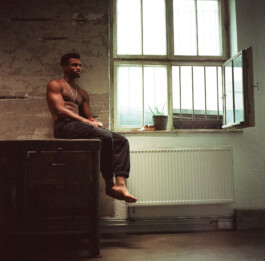 black-male-athlete-sits-window-sill-grainy-amalog 