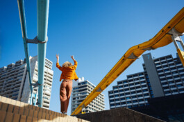 exhuberant-happy-dancing-by-yourself-orange-colorblock-outfit-architecture 