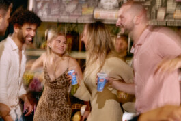 group-of-friends-dancing-drinks-in-hands-motion-blur 