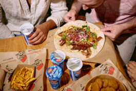 messy-dinner-table-food-kebap-ayran-pommes-french-fries-enjoying-eating-together 