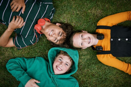 three-teenage-friends-topdown-view-lying-in-a-circle-smiling