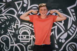 young-teenage-boy-confident-muscle-pose-graphic-popart-background