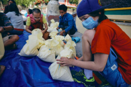nepal-2015-earthquake-relief-effort-young-boy-packing-food-parcel 